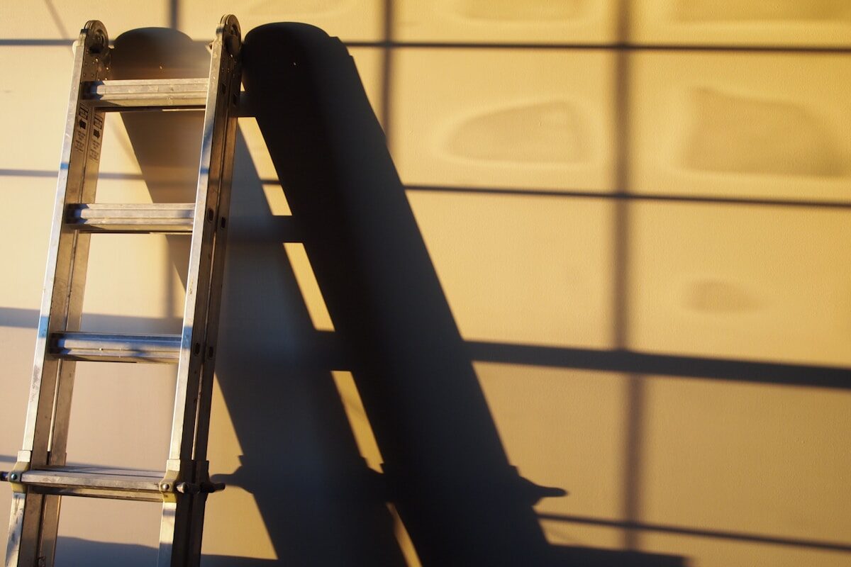 A ladder leaning against a freshly finished interior wall